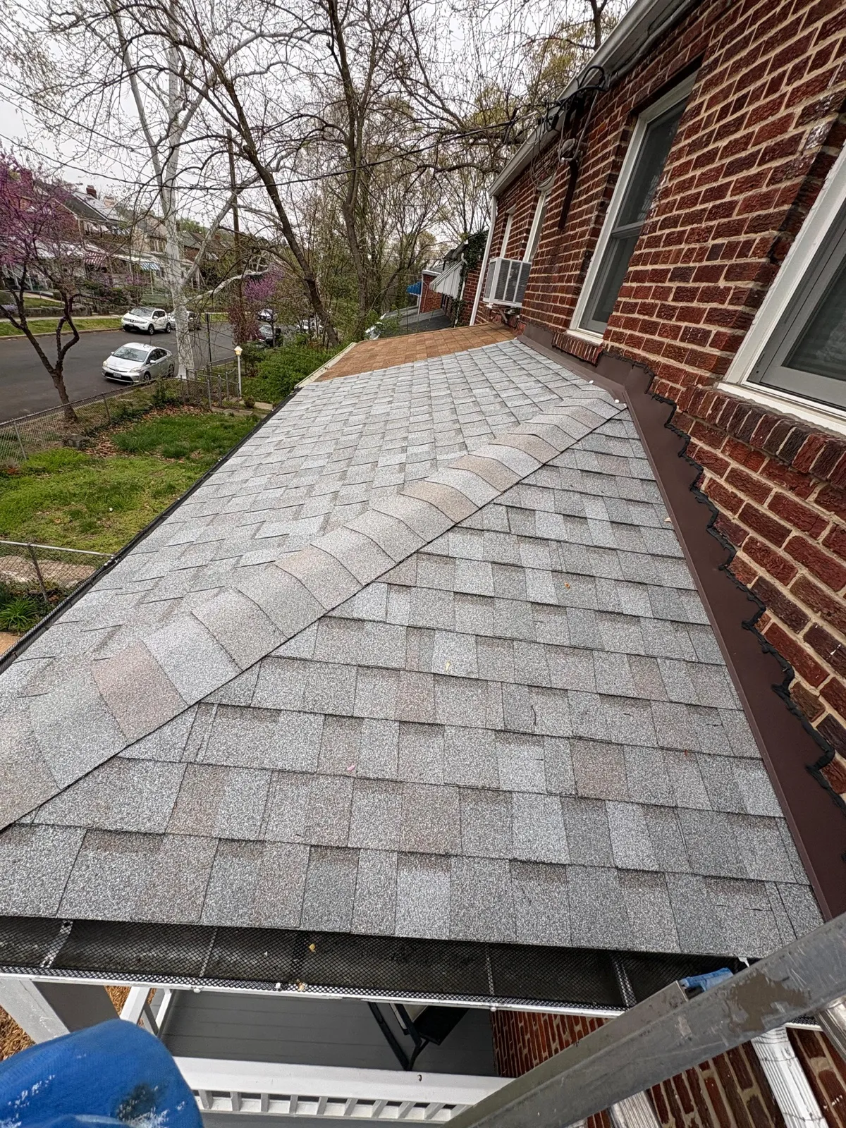 New asphalt shingle roof installed on a brick home