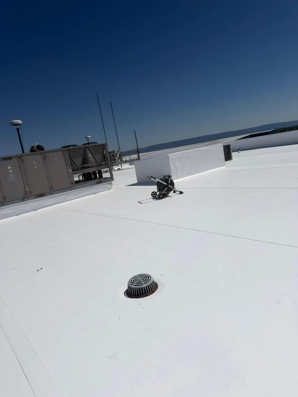 Large white TPO membrane on industrial building