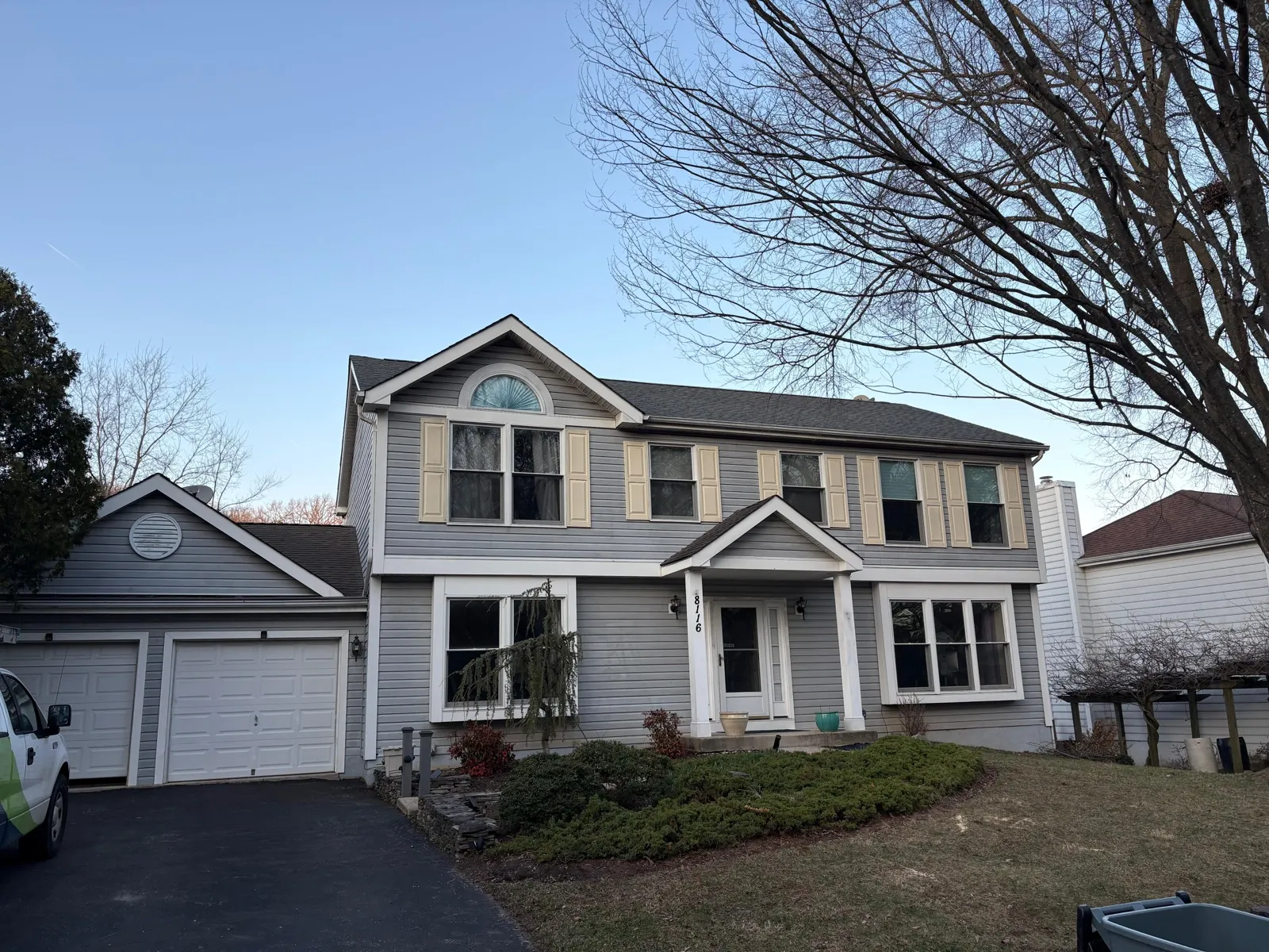 Front elevation of home with new gray siding