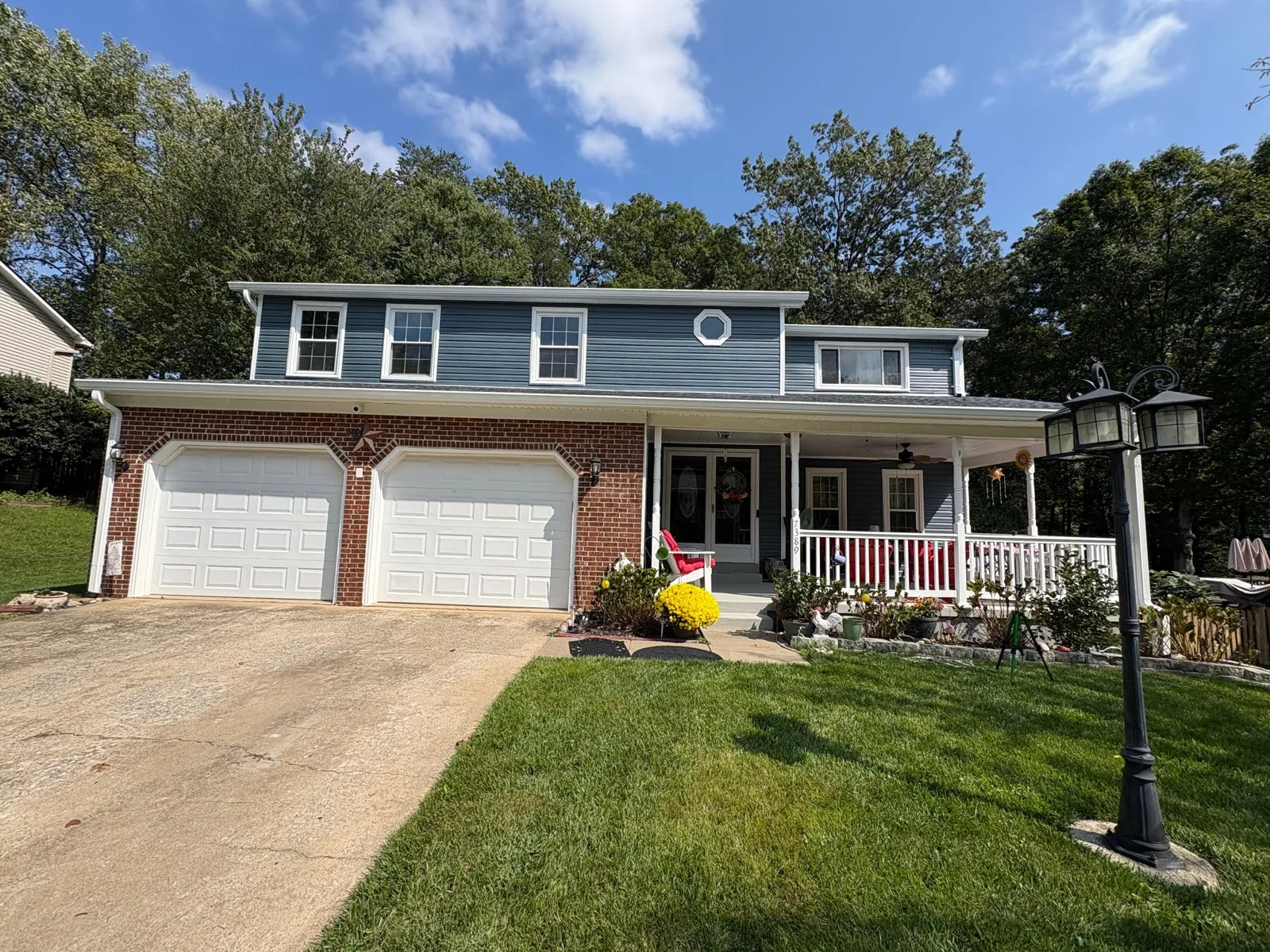 Completed blue siding home with covered porch