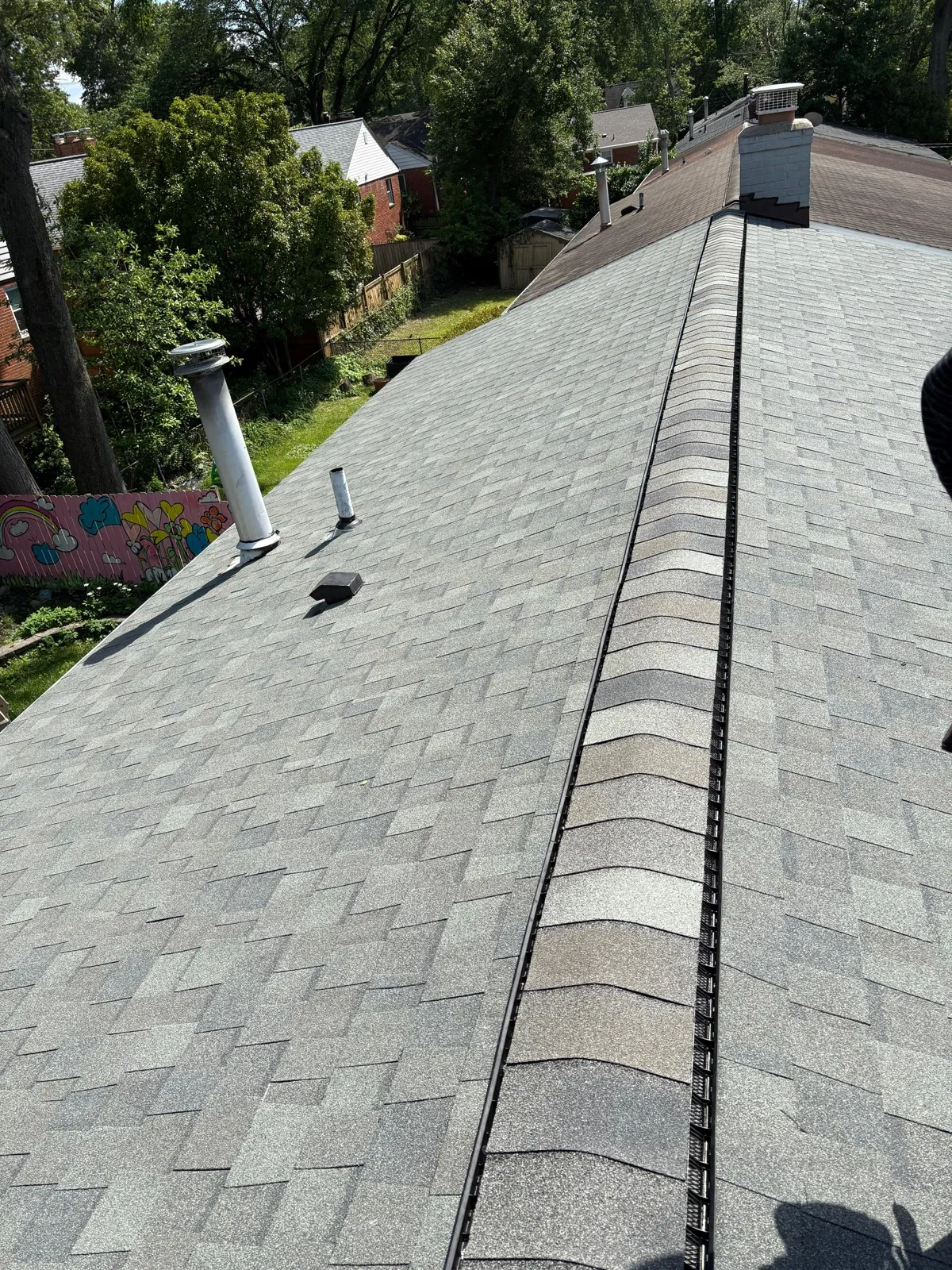 Ridge of asphalt shingle roof with ventilation