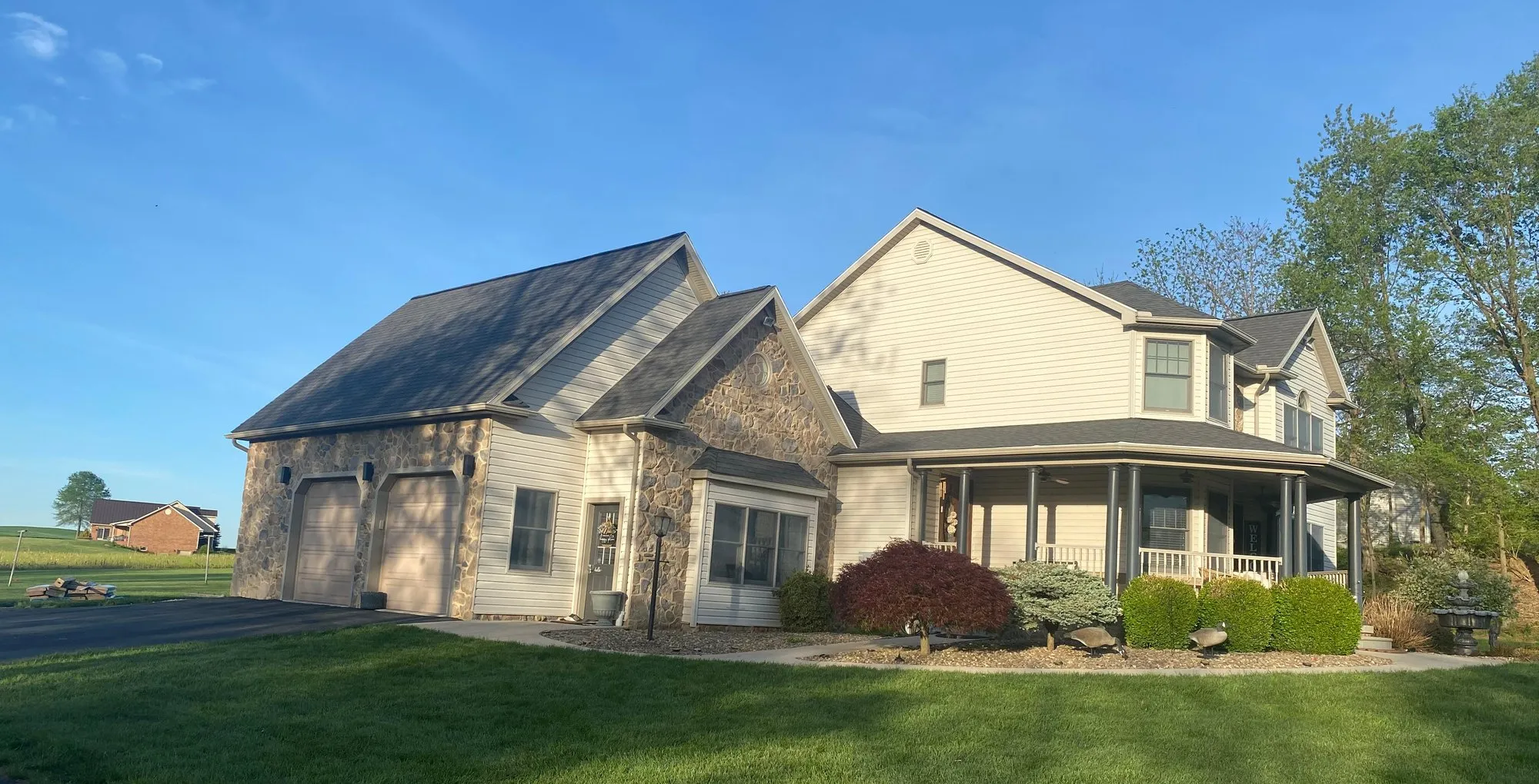 Stone and siding home with a new architectural shingle roof