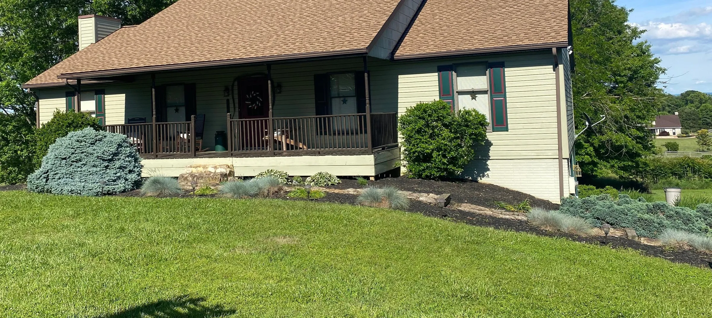 Ranch home with a new brown architectural shingle roof and porch